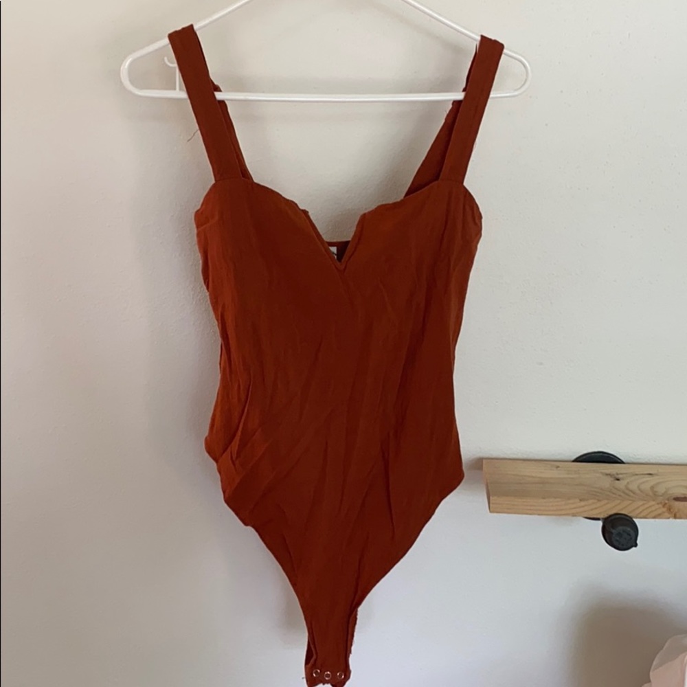 Rust orange bodysuit.